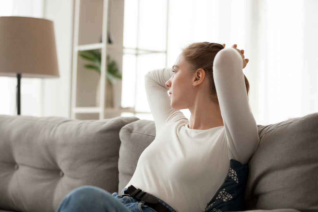 Woman sat on sofa thinking of the future