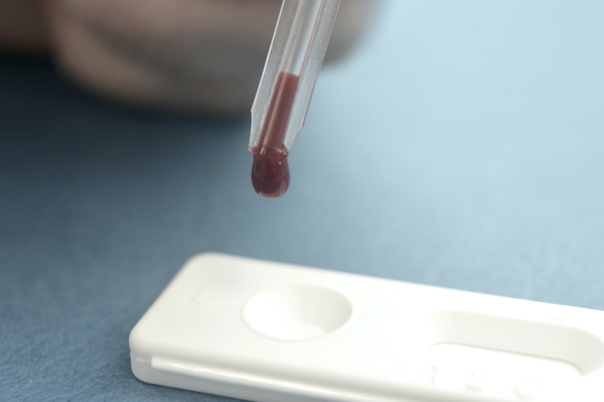Drop of blood being added to a SELFCHECK self-test kit